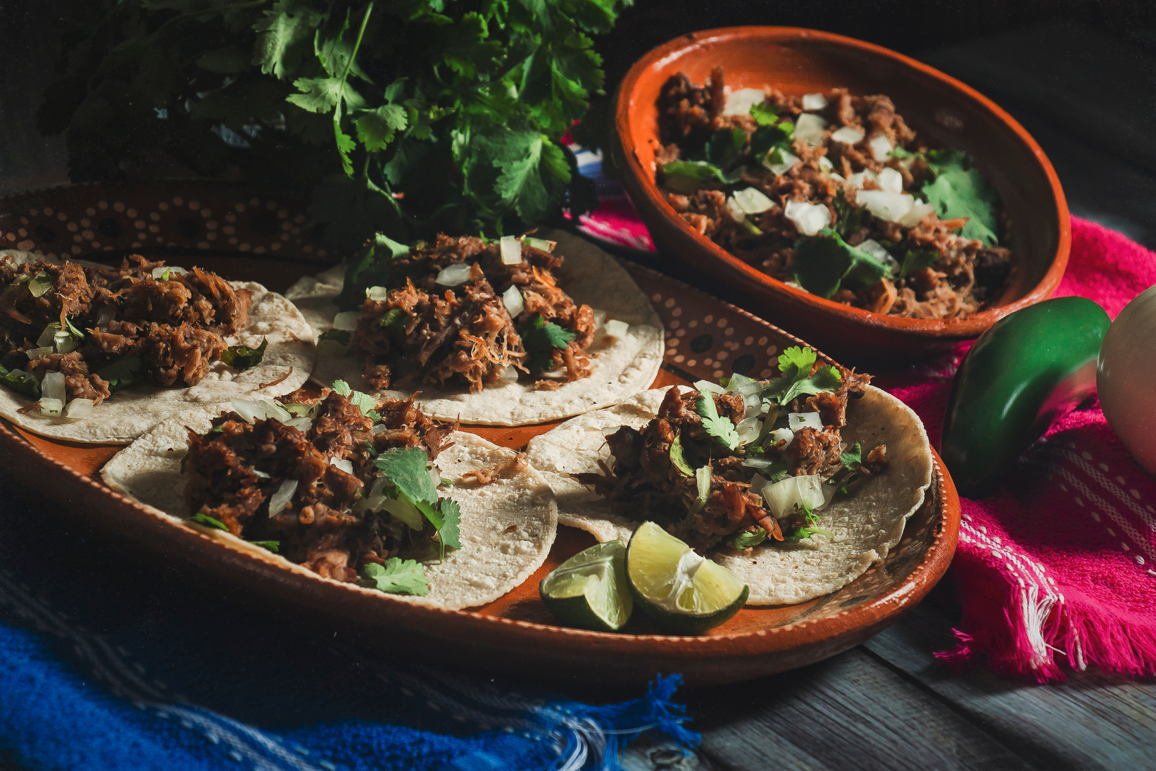 Tacos of Barbecue on Mexican Clay Plates on Tablecloths